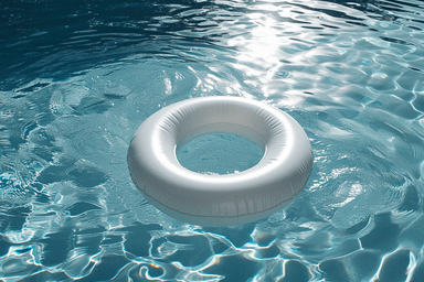 A white inflatable ring floating in a pool