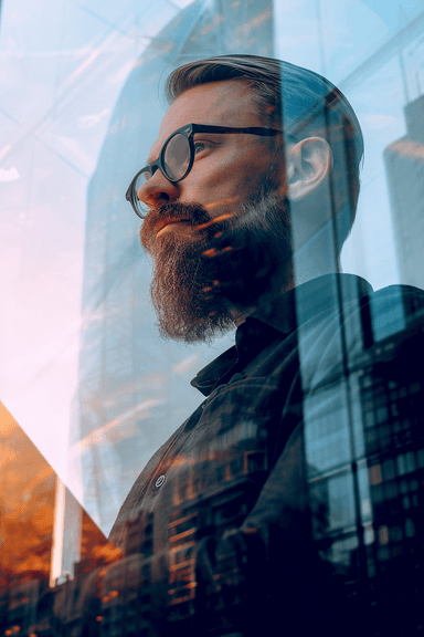 A man with a beard and glasses looking out a window