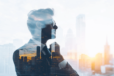 A man standing in front of a window talking on a cell phone