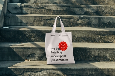 Tote Bag Mockup Placed on Concrete Stairs in Sunlight
