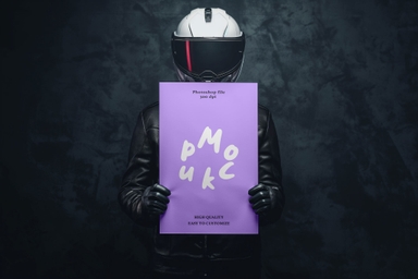 Biker Holding Vertical Paper Mockup