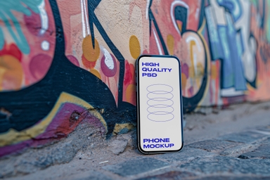 Smartphone Mockup Against Urban Art Wall