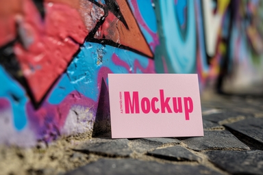 Business Card Mockup Leaning Against Graffiti Wall