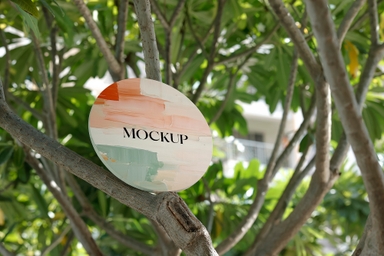 Round Canvas Mockup Placed on Tree Branch