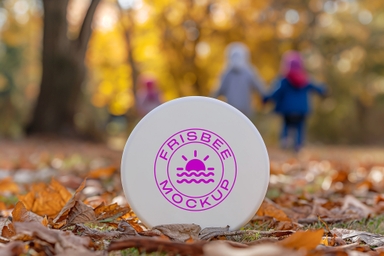 Frisbee Mockup Standing in Garden on Dry Leaves