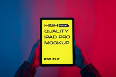 Hand Showcasing iPad Pro Mockup in Neon Ambiance