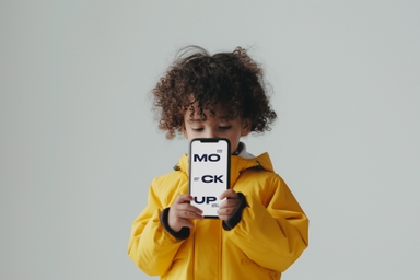 Toddler Showcasing Smartphone PSD Mockup