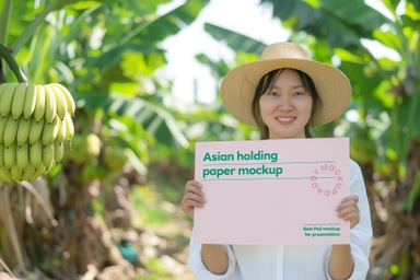 Asian Female Holding Paper Mockup in Banana Orchard