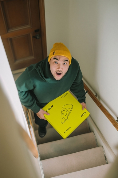 Asian Delivery Man Presents Pizza Box Mockup