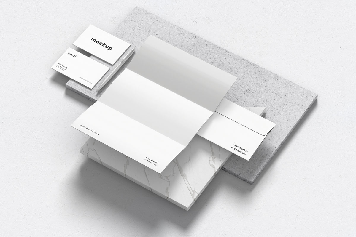 Black and white branding mockup with pen, envelope, and business cards