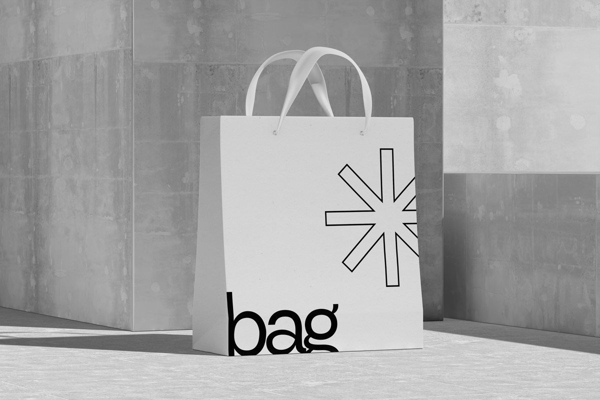 White paper bag with star mockup on concrete floor