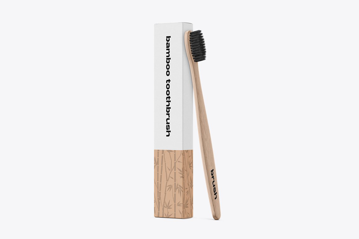 brown Bamboo Toothbrush with black bristles and packaging box mockup