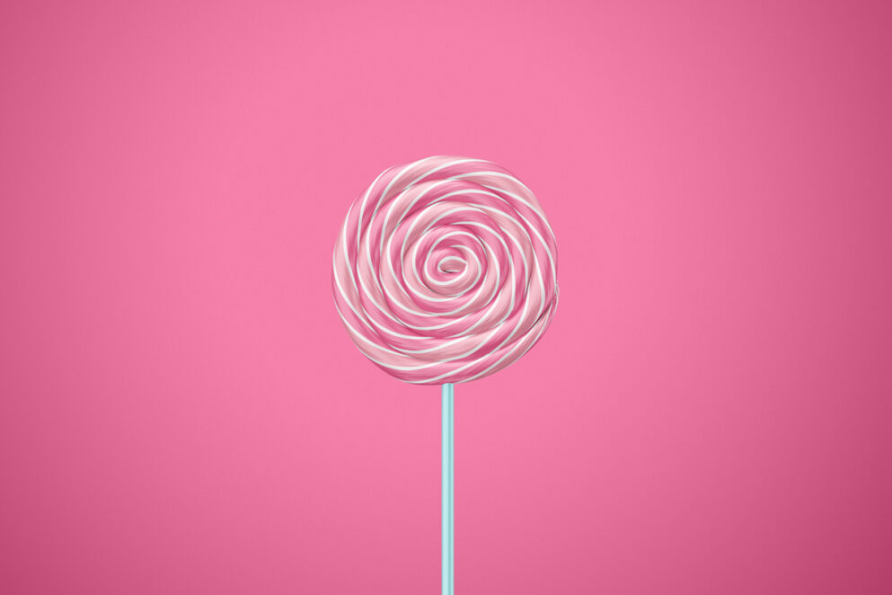 Swirl lollipop in pink and white colors on white stick
