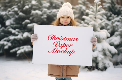 Girl holding horizontal paper mockup in snow-