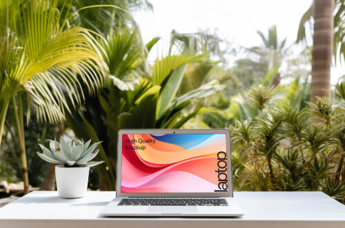 MacBook Pro mockup on a white table beside a potted plant
