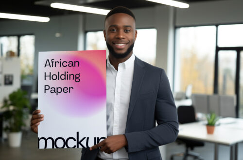 Close-up african man holding paper mockup in office-